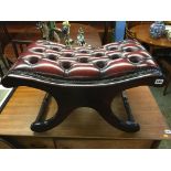 An oxblood Chesterfield stool