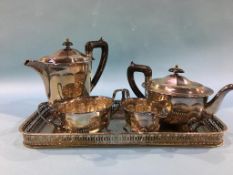 A silver plated tray and a four piece tea service