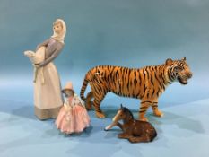 A Beswick standing tiger, a Royal Doulton figure 'Lily' HN1798 etc.