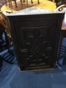 An oak hanging corner cabinet