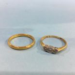 An 18ct gold diamond three stone ring and a 22ct gold wedding band, 2.5 gram, (total weight 4.7