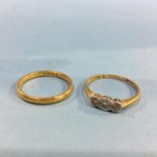 An 18ct gold diamond three stone ring and a 22ct gold wedding band, 2.5 gram, (total weight 4.7