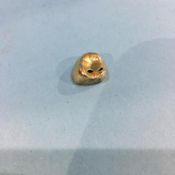 A gold tooth cap, weight 1.4 gram