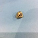 A gold tooth cap, weight 1.4 gram