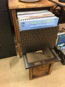 An oak 'The Barkingside' record cabinet and records, with pull out front opening to reveal record