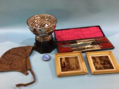 A cased carving set, a silver and blue enamelled compact, a silver plated cup, a leather