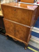 A walnut Queen Anne style cocktail cabinet