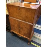 A walnut Queen Anne style cocktail cabinet