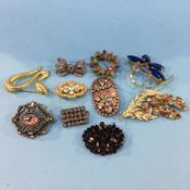 Ten decorative brooches