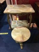 An Onyx two tier table and a circular onyx occasional table, both with decorative heavy brass