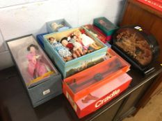 A boxed Casdon 'Cradle', a boxed See-saw and a quantity of boxed dolls