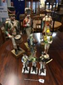 A Continental majolica style pottery figure, three carved wood figures etc.