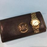A Michael Kors black leather purse and a Marc Jacobs wrist watch