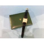 A 9ct gold Rolex watch, with rectangular dial, second hand dial, batons, leather strap, with leather