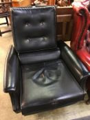 A 1970s black vinyl swivel armchair