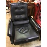 A 1970s black vinyl swivel armchair