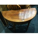 A 19th century mahogany demi lune fold over tea table