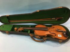 A child's violin, with bow and case