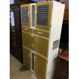 A fantastic 1950's kitchen cabinet, with drop down enamel front opening to reveal compartments for