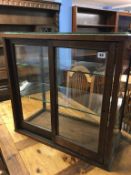 A shop counter display cabinet with sliding doors, 66cm wide x 33cm deep