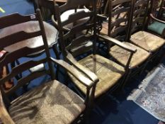 A set of four oak ladder back chairs