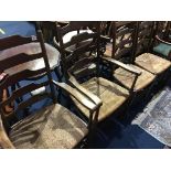 A set of four oak ladder back chairs