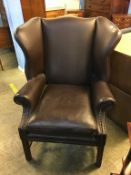 Brown leather wingback armchair