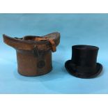 A top hat and leather case