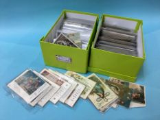 A collection of various postcards, in two boxes