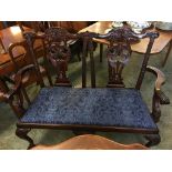 Heavily carved reproduction mahogany two seater sofa