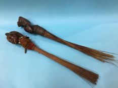 Two carved African fly swats