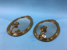 Pair of mirrored brass wall sconces