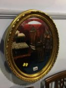 Gilt framed oval mirror