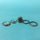 Three gold coloured rings and two others (5)