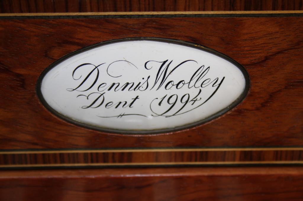 A piano by Dennis Woolley Dent (dated 1994), in a walnut case, supported on square tapering legs.