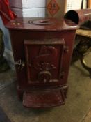 An enamelled Lange and Co. barge log burner 52 cm Height by 38 cm wide