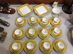 A Wedgwood tea service, pattern W437, comprising twelve trios, two cake plates, sugar bowl and cream