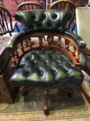 A green leather buttoned Chesterfield office chair