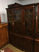 A reproduction mahogany breakfront bookcase, with three glazed doors and cupboards below, 157cm
