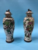 A slender pair of Chinese vases, decorated with warriors, 33cm height