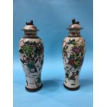 A slender pair of Chinese vases, decorated with warriors, 33cm height