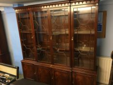 A reproduction mahogany four door breakfront bookcase, 203cm width x 215cm height x 37cm depth