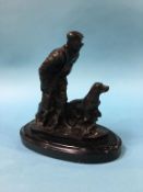 A small modern bronze group of a gamekeeper and his dog