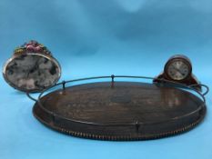 A 1920's oak oval tea tray, a barbola mirror and an Edwardian mantel clock (3)