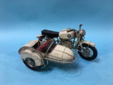 A metalwork model of a motorbike and sidecar