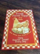 A modern 'Fresh Farm Eggs' enamel style sign