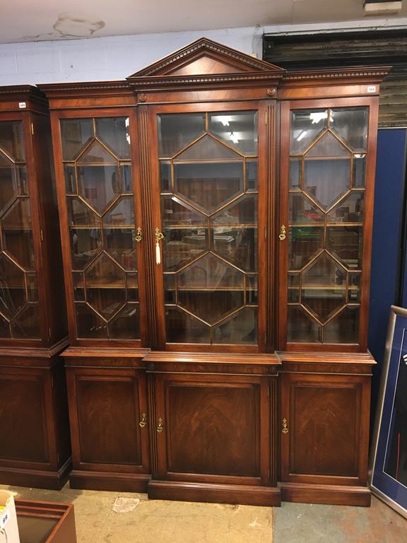 A reproduction mahogany breakfront bookcase, with three glazed doors and cupboards below, 157cm