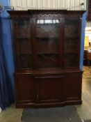 A reproduction mahogany breakfront three door bookcase, with cupboards underneath, 156cm width,
