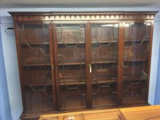 A reproduction mahogany four door breakfront bookcase, 203cm width x 215cm height x 37cm depth