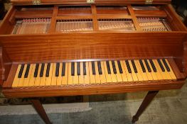 A mahogany cased harpsichord supported on turned legs and brass hinges. 196cm length x 83cm wide